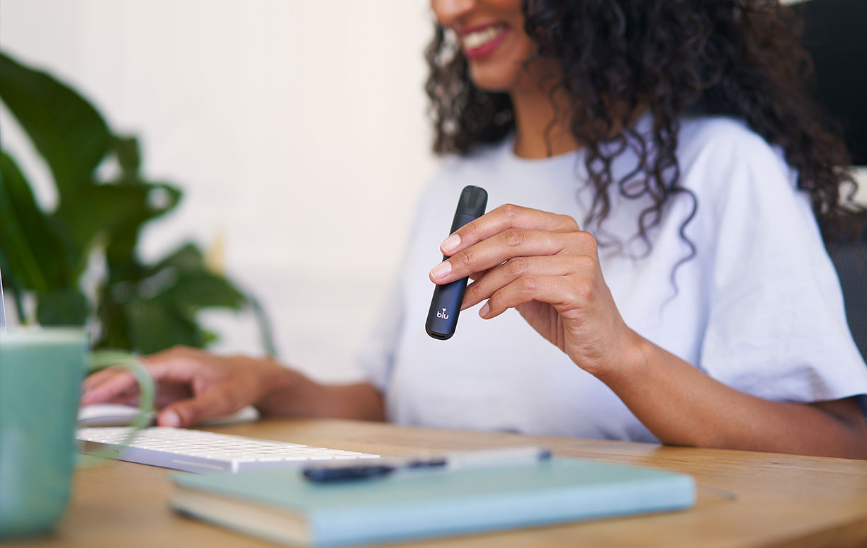 Woman Vaping at Workstation